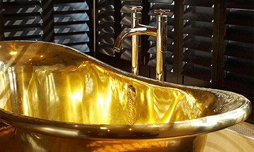 brass freestanding bath in a bathroom setup