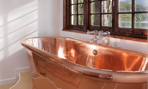 copper freestanding bath in a bathroom setup
