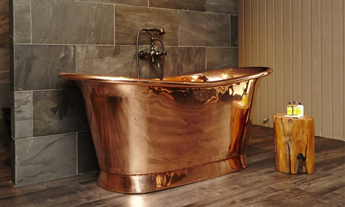 William Holland copper bath in a bathroom set up
