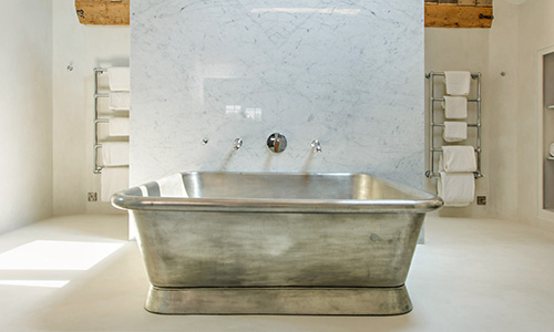 tin freestanding bath in a bathroom setup