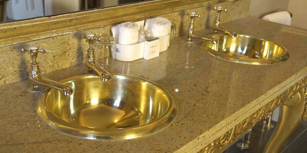 brass basins by William Holland in a commercial bathroom set up