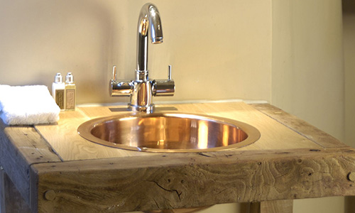 William Holland brass basin in a bathroom decor